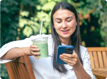 Happy MyArabisc customer browsing print-on-demand products on smartphone outdoors